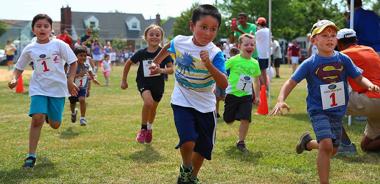Youths Participate in the Children's Fun Run During Katie's Run in June 2016. Photo Courtesy of LI Sports Shots. Image of Youth Participating in the Children's Fun Run During Katie's Run 2016