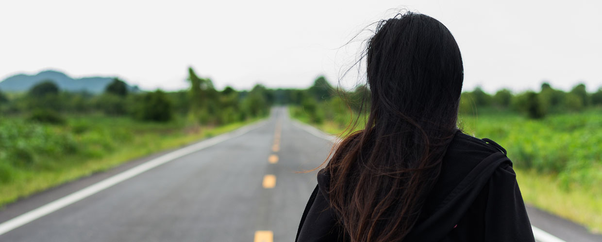 Woman Looks Down Long Road of Grief
